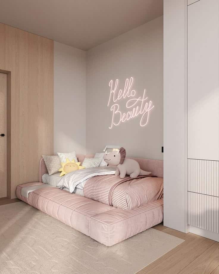 Cozy kid's bedroom with a pink bed, plush toys, and Hello Beauty neon wall sign, styled in soft, neutral tones.