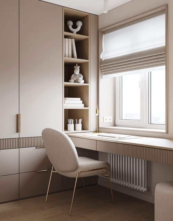 Modern home office with elegant beige desk, chair, and shelves near a sunlit window. Minimalist and stylish workspace setup.