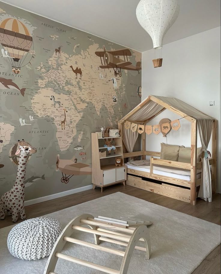Cozy kids' room with world map mural, wooden furniture, and hot air balloon decor. Perfect for imaginative play.