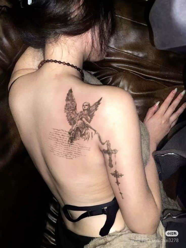 ━ 𝐡𝐚𝐳𝐞𝐥 ☻ Person with an intricate angel tattoo on their back, showcasing detailed wings and a cross design. | Sky Rye Design Person with an intricate angel tattoo on their back, showcasing detailed wings and a cross design.