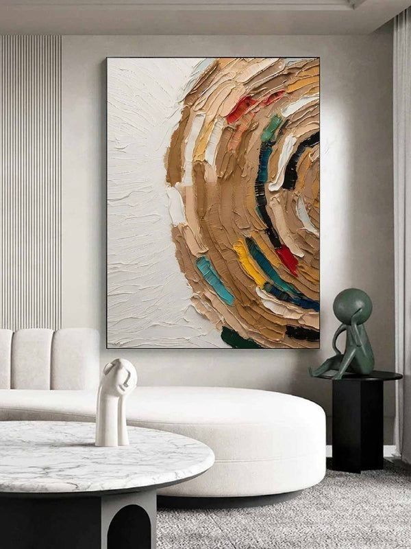 Abstract textured painting with earthy tones and splashes of color in modern living room setting.