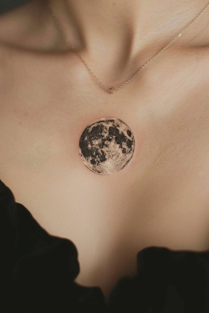 Elegant necklace with moon pendant on person’s chest, capturing celestial theme and refined style.