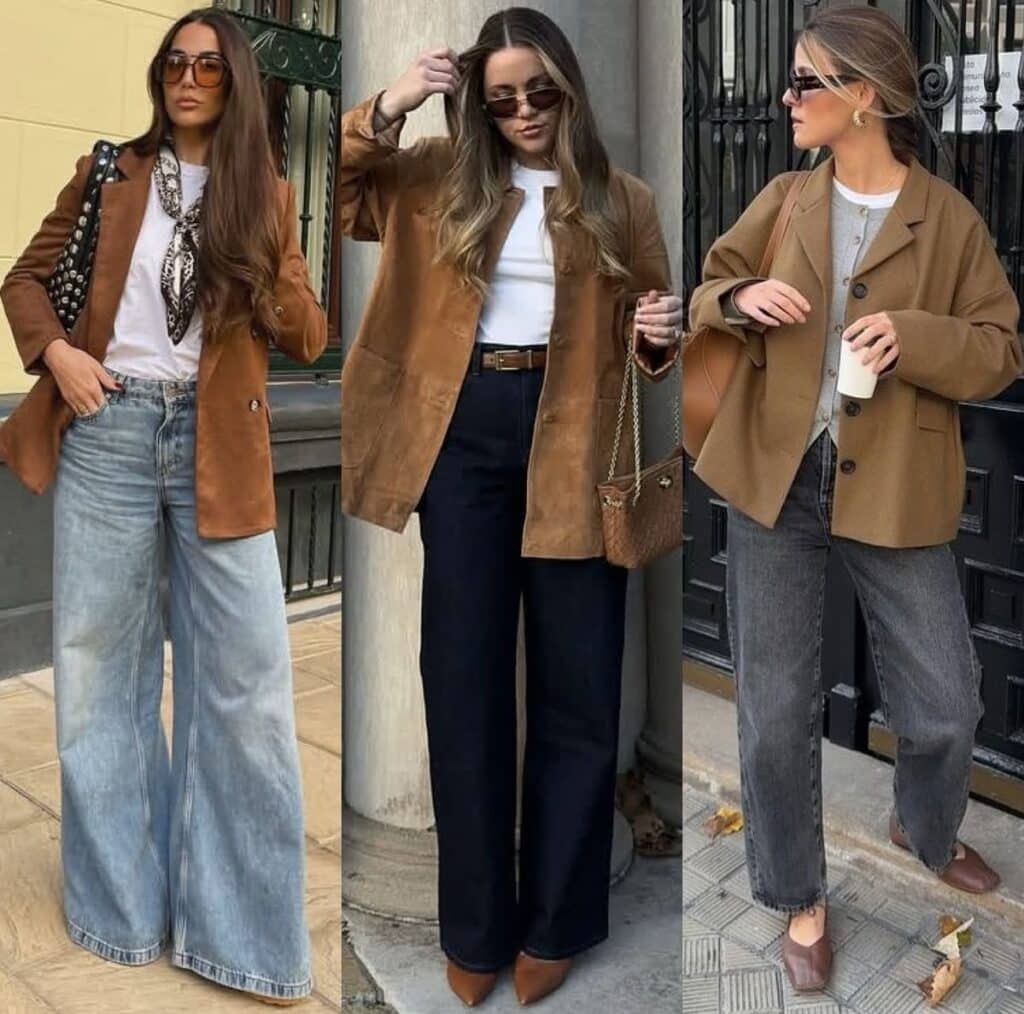 Three women in stylish wide-leg jeans and brown blazers, accessorized with sunglasses and bags, showcasing fall fashion.