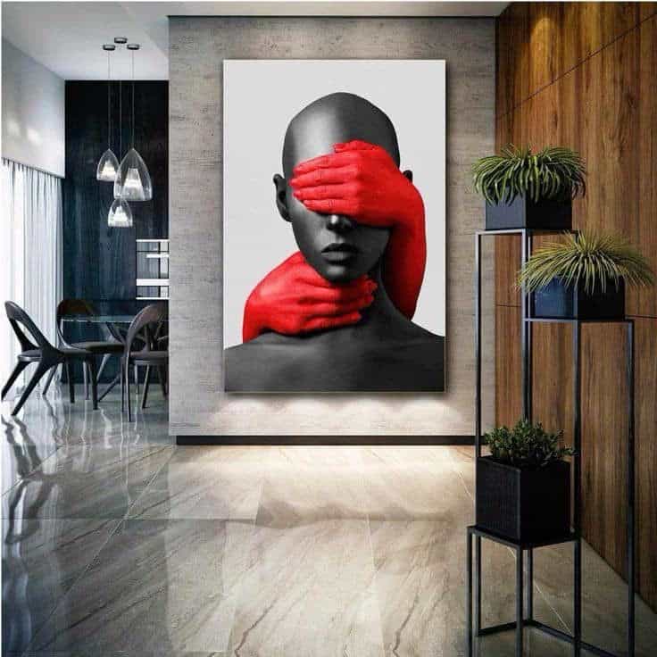 Modern interior with striking art: monochrome bust covered by red hands.