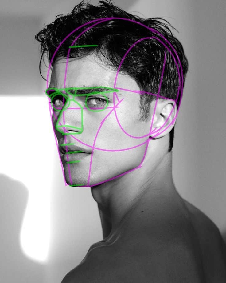 Profile of a man with outlined facial symmetry guides in a grayscale photo, highlighting structure and proportions.