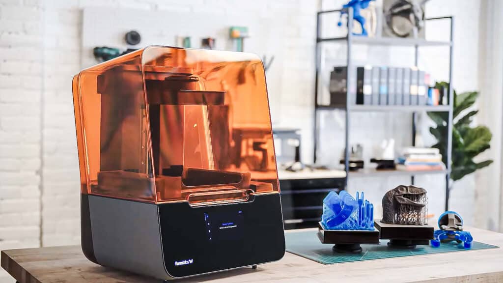 Sleek 3D printer in modern workspace with resin models, showcasing advanced technology for innovative designs.