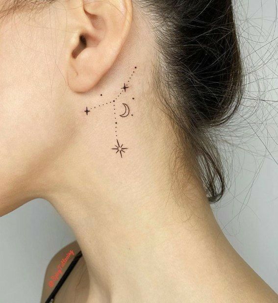 Minimalist constellation tattoo behind the ear, featuring stars and a crescent moon design on a woman's skin.
