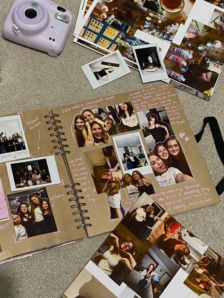 Scrapbook with photos and a lavender instant camera on a floor, capturing joyful moments and creative memories.