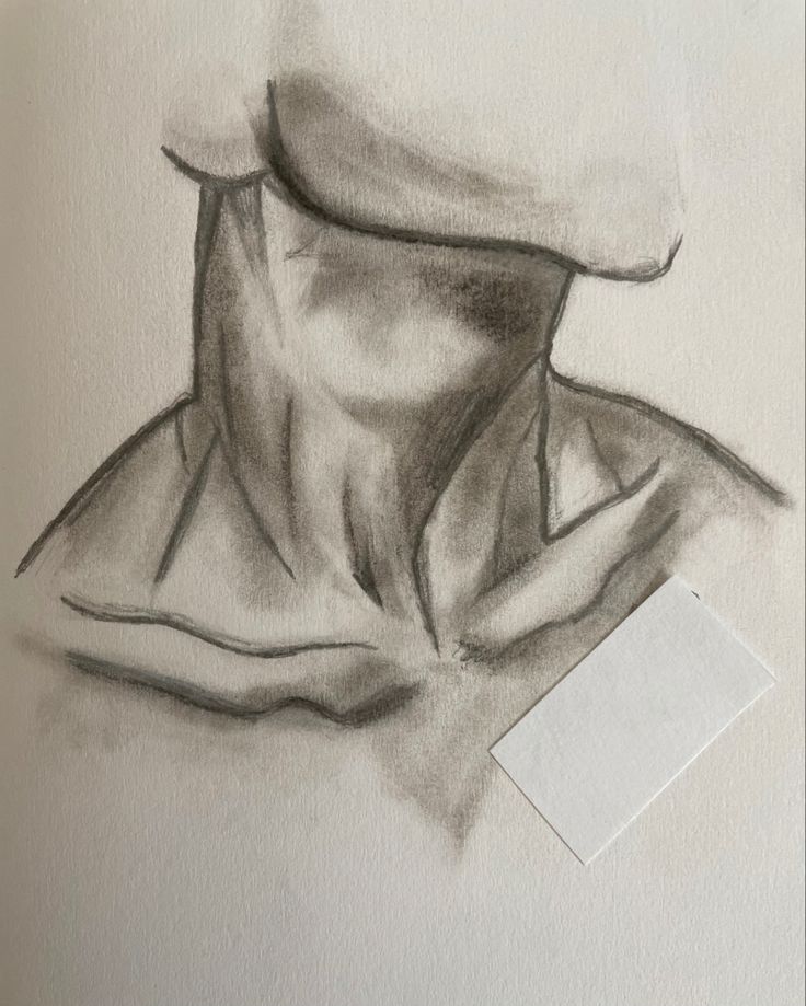 Charcoal sketch of a draped cloth, showing shadows and textures, with a rectangular blank note at the bottom right.