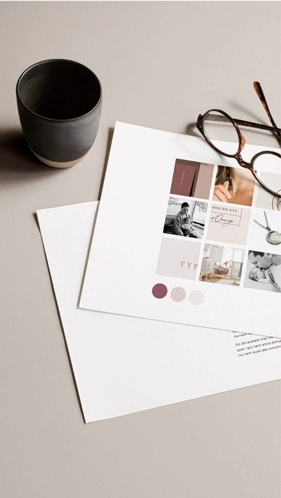 Minimalist workspace with mood board, glasses, and coffee cup on a beige desk.