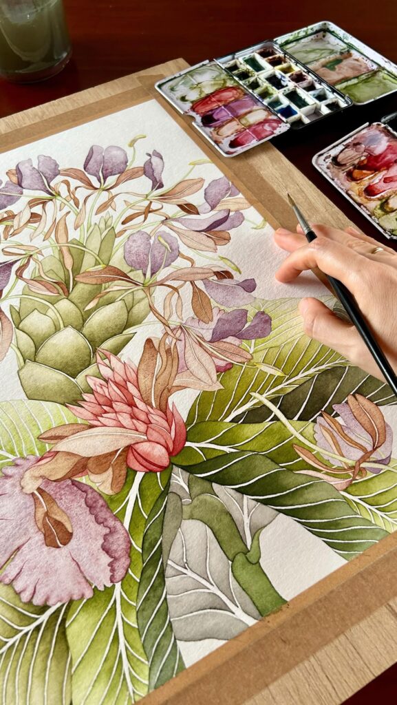 Artist painting botanical watercolor with vibrant greens and purples using a palette and brush, intricate floral design.