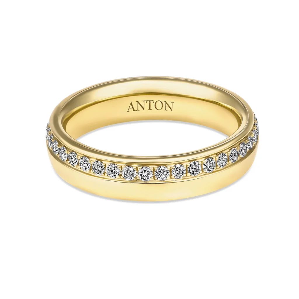 Gold ring with diamond accents engraved with the name ANTON, showcasing elegance and luxury jewelry design.