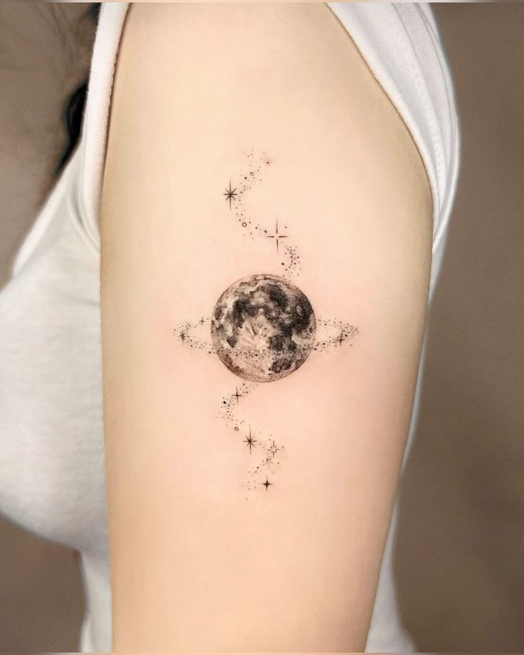 Minimalist moon and stars tattoo on arm in black and gray design, showcasing celestial theme and fine line details.