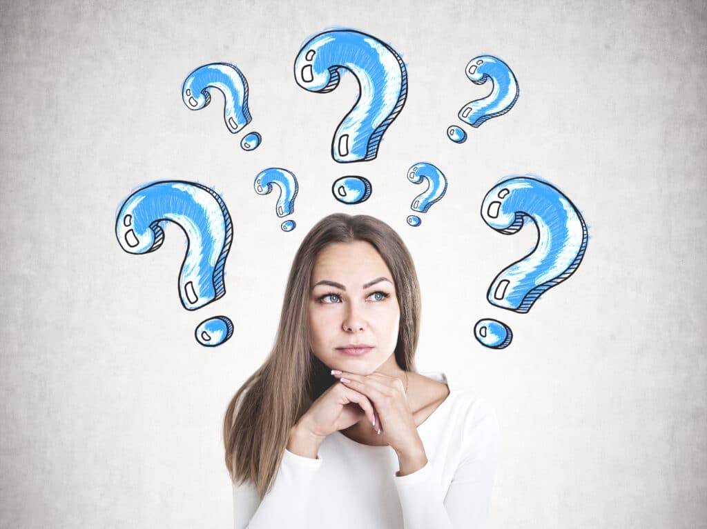 Woman thinking with blue question marks above her head, pondering a decision or solution.