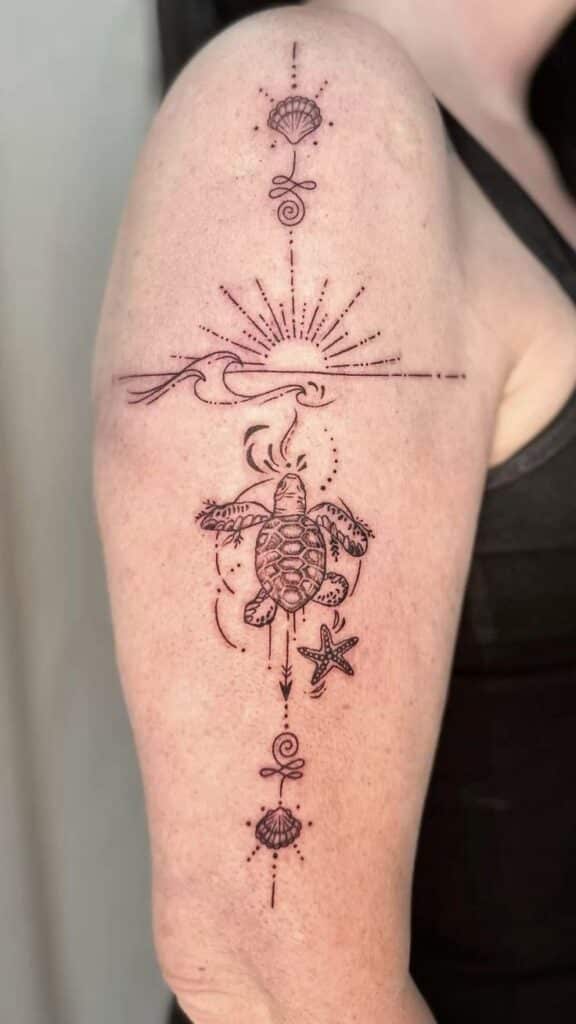 Minimalist turtle tattoo with seashells and starfish design on arm, featuring sun and sea elements.