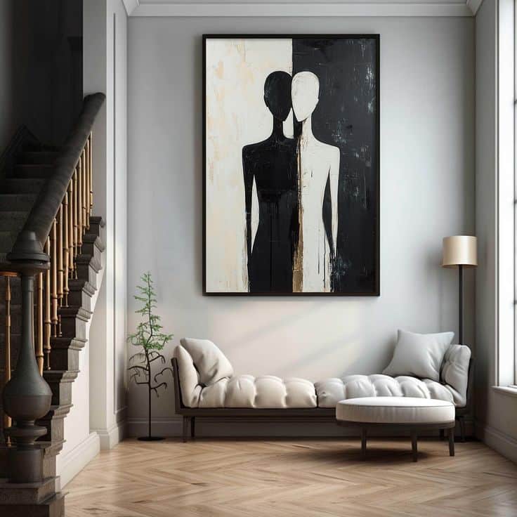 Modern living room with a monochrome abstract painting, elegant staircase, and cozy seating area with natural light.