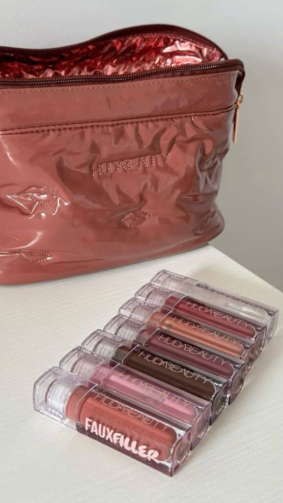 Cosmetic bag and assorted lipsticks on a table, perfect for makeup lovers and beauty enthusiasts.