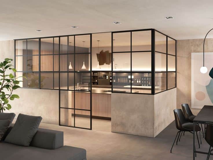 Modern kitchen with glass partitions and wooden cabinets, open design, pendant lights, and adjacent dining area.