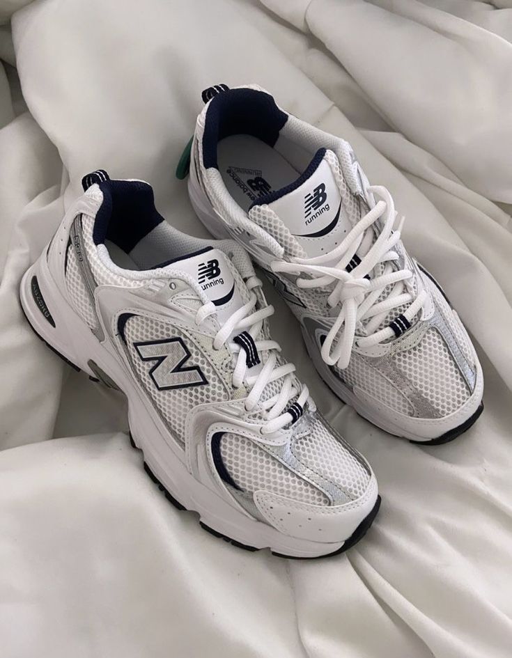 White running shoes with mesh design on a white background, showcasing classic sporty style and comfort.