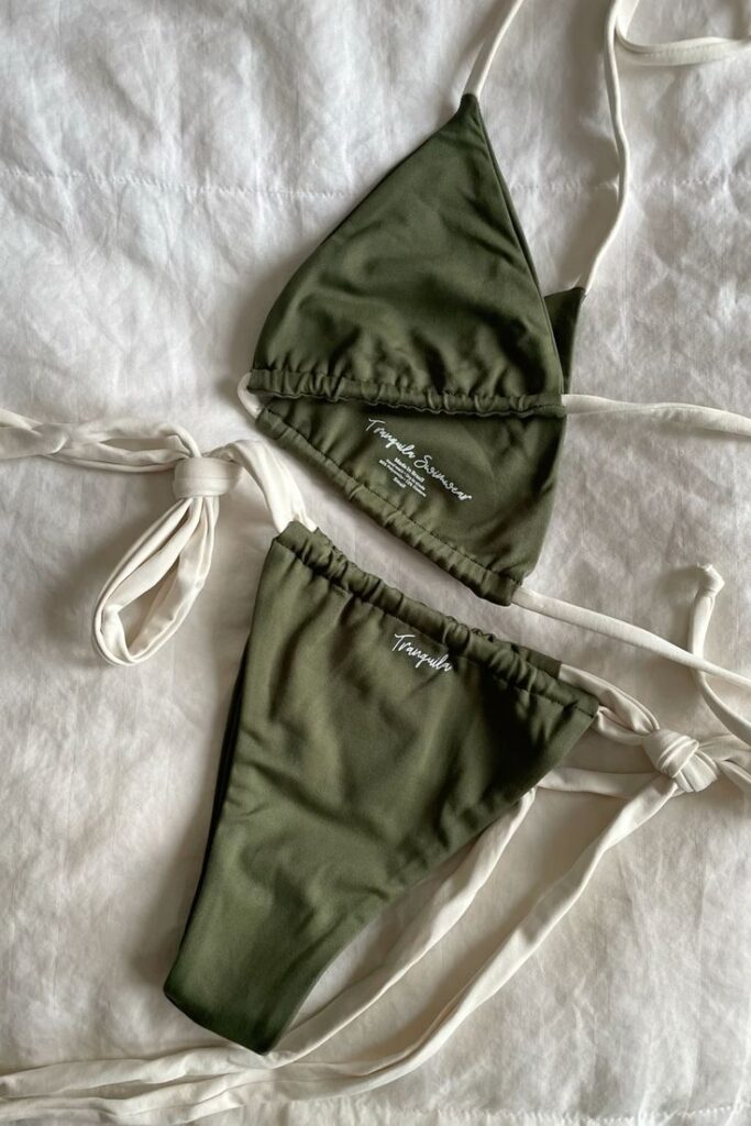 Olive green bikini set with white straps on a white background, featuring side ties and a minimal design.