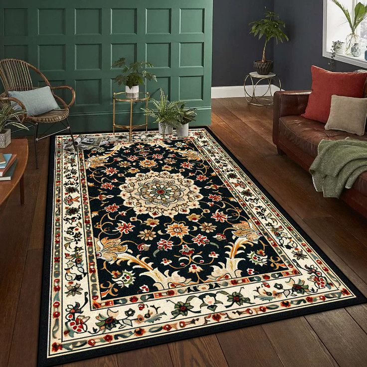 Elegant patterned rug in a cozy living room with hardwood floors, green paneled wall, and indoor plants.