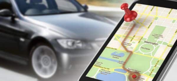 GPS navigation on smartphone screen with car in motion, highlighting route and destination with a red map pin.