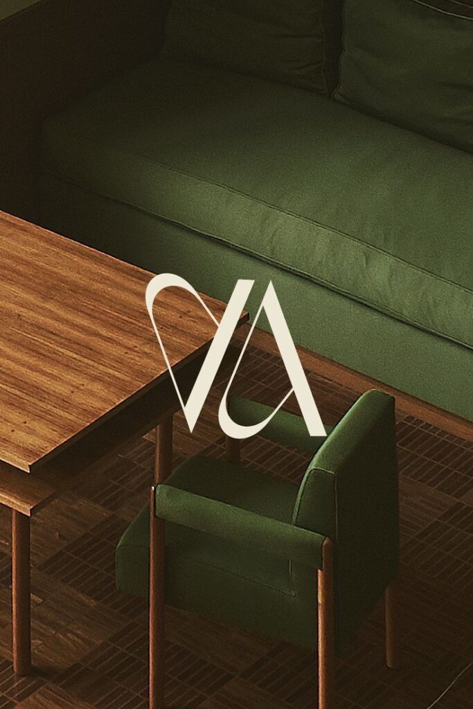 Modern green sofa and chair with a wooden table, featuring a stylish logo overlay.