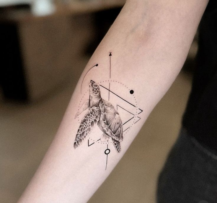 Geometric sea turtle tattoo on forearm with abstract design and lines.