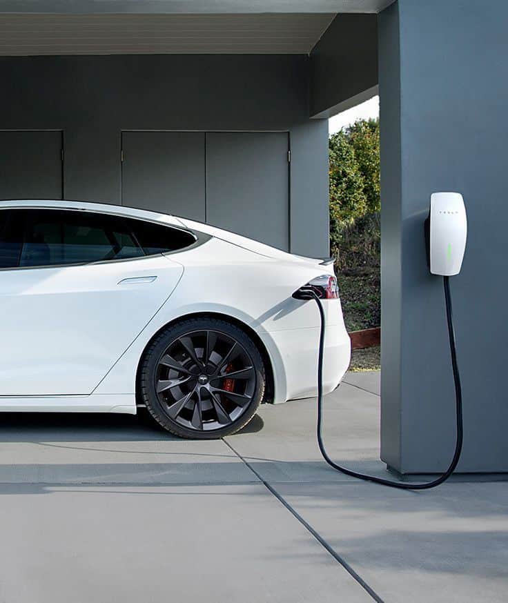 Electric car charging at home station, showcasing eco-friendly transportation and sustainable technology.