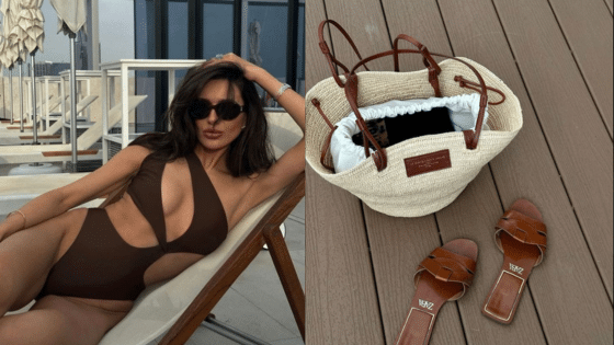 Woman in brown swimsuit relaxing on a lounge chair beside a straw bag and sandals on wooden deck.