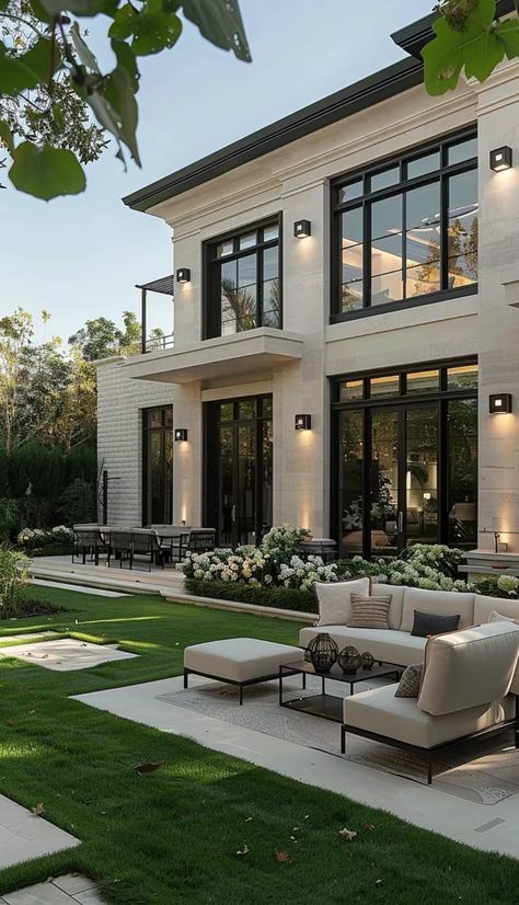 Modern luxury home with spacious patio, outdoor seating, and lush garden in a serene setting.