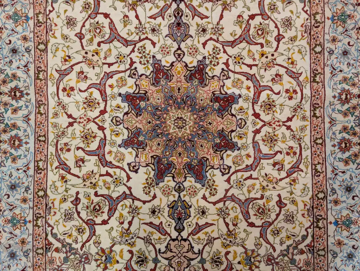 Ornate floral Persian rug design with intricate patterns in red, blue, and cream colors.