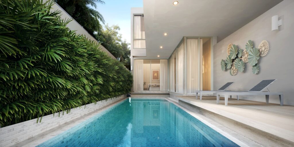 Modern backyard with sleek pool, patio loungers, lush greenery, and contemporary wall decor for a luxurious outdoor vibe.