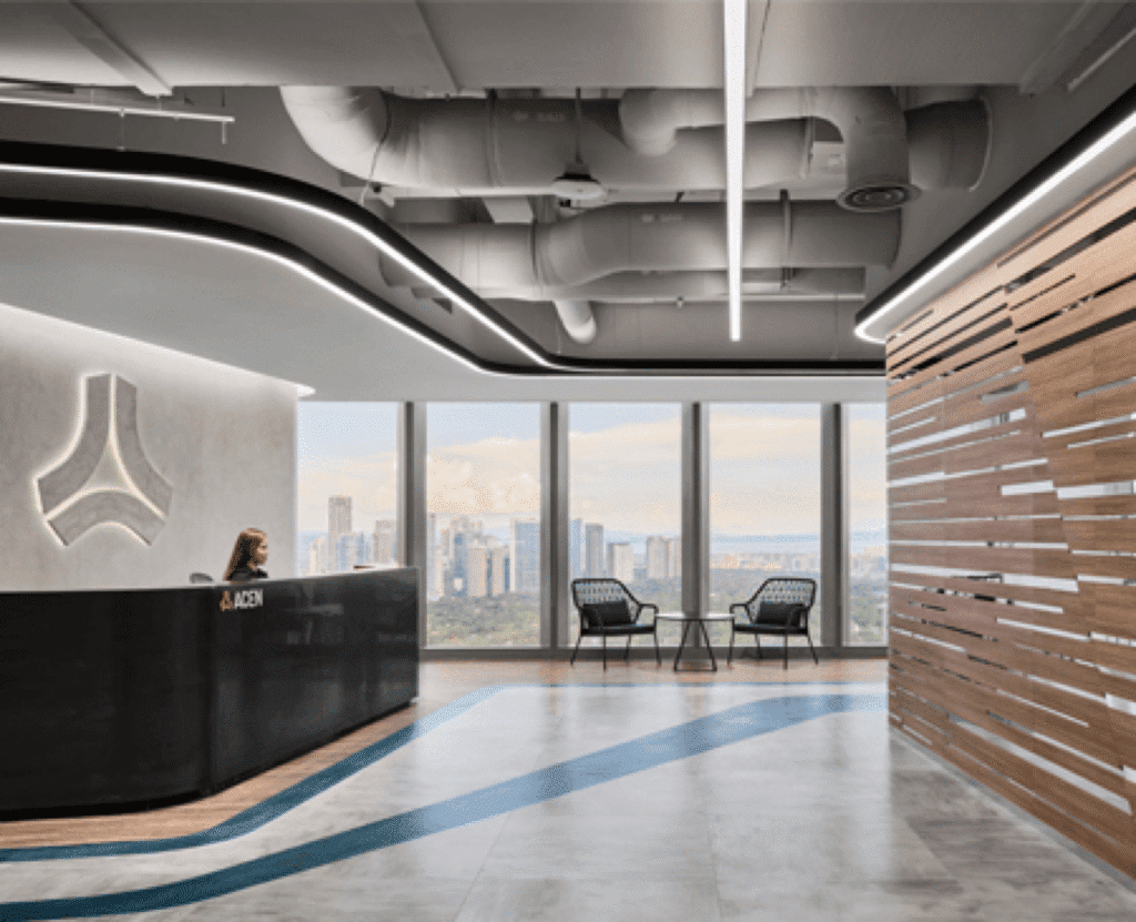 Modern office lobby with sleek reception desk, city view, and unique ceiling design.