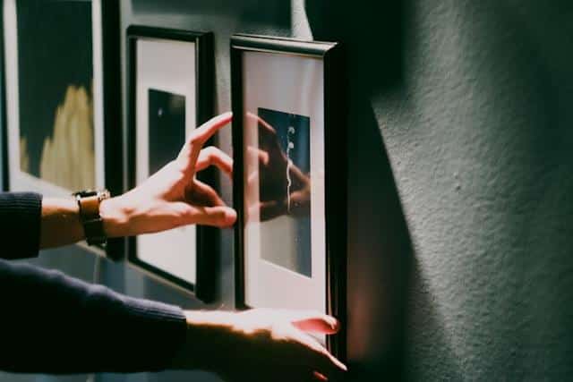 image2 | Sky Rye Design Person hanging pictures on a wall