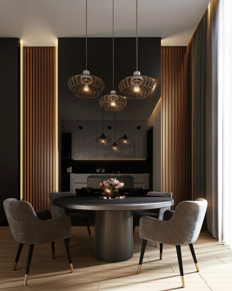 Elegant dining area with modern pendant lights, round table, and plush chairs in stylish interior design setting.