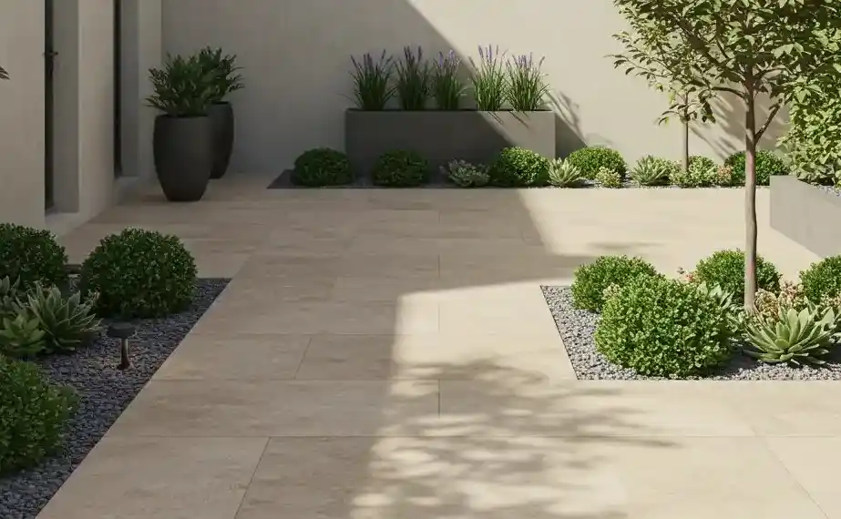 Modern patio with beige tiles, lush green landscaping, potted plants, and decorative planters in a minimalist design.