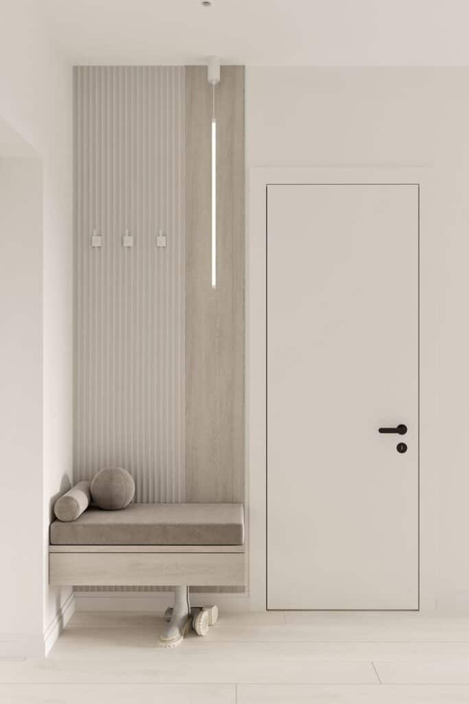 Современная светлая прихожая_ Дизайн проект от студии дизайна интерьера Soprano Minimalist hallway with beige bench, modern hooks, and clean lines for stylish entryway decor. | Sky Rye Design Minimalist hallway with beige bench, modern hooks, and clean lines for stylish entryway decor.