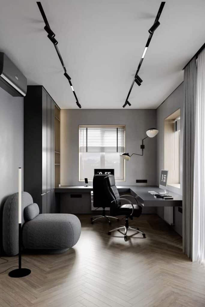 Тёмный кабинет с функциональным освещением и двумя рабочими зонами _ Dark Office with Track Lighting Modern home office with sleek furniture, wooden floor, track lighting, and large window for natural light. | Sky Rye Design Modern home office with sleek furniture, wooden floor, track lighting, and large window for natural light.