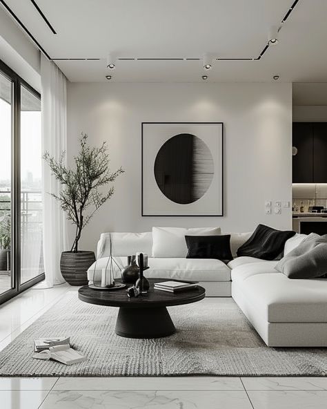 Modern living room with white sofa, abstract art, round table, and potted plant in natural light.