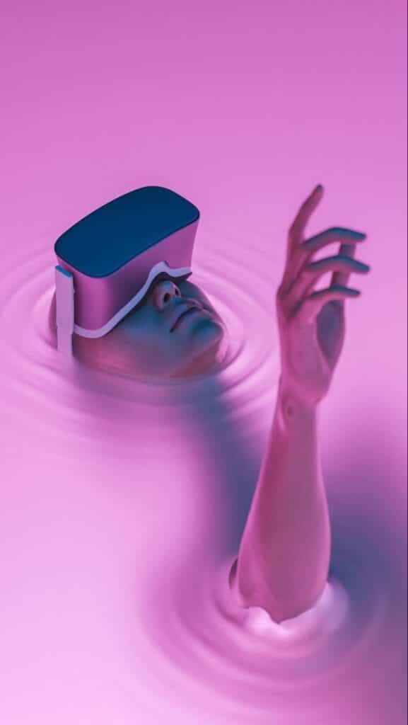 Person with VR headset submerged in pink liquid, arm reaching out, symbolizing immersive virtual reality experience.
