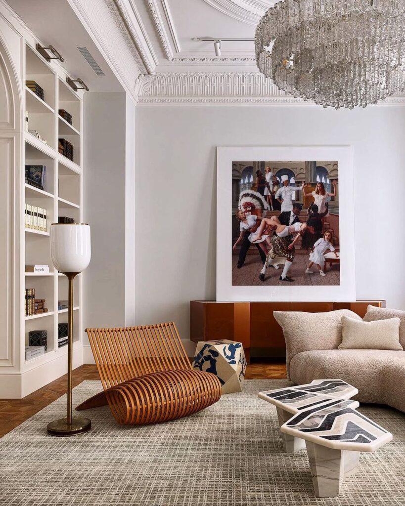 Luxurious living room with modern furniture, elegant decor, and a large chandelier.
