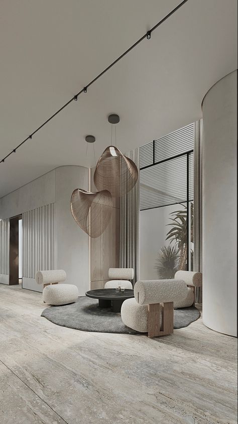 Modern minimalist living room with chic furniture, textured walls, and artistic lighting fixture.