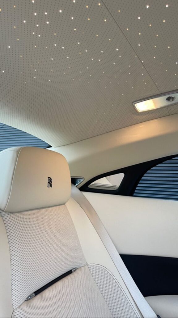 Luxury car interior with starlit ceiling and elegant leather seating, showcasing premium design and craftsmanship.