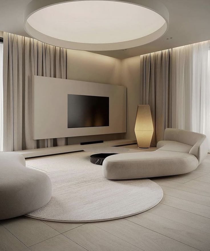 Modern minimalist living room with curved sofas, large TV, and soft lighting. Contemporary interior design focus.