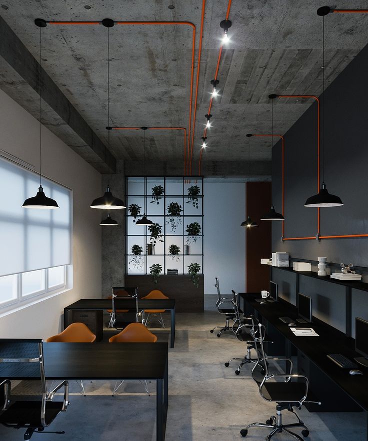 Modern office with industrial decor, exposed pipes, small plants, and ambient lighting for a contemporary workspace.