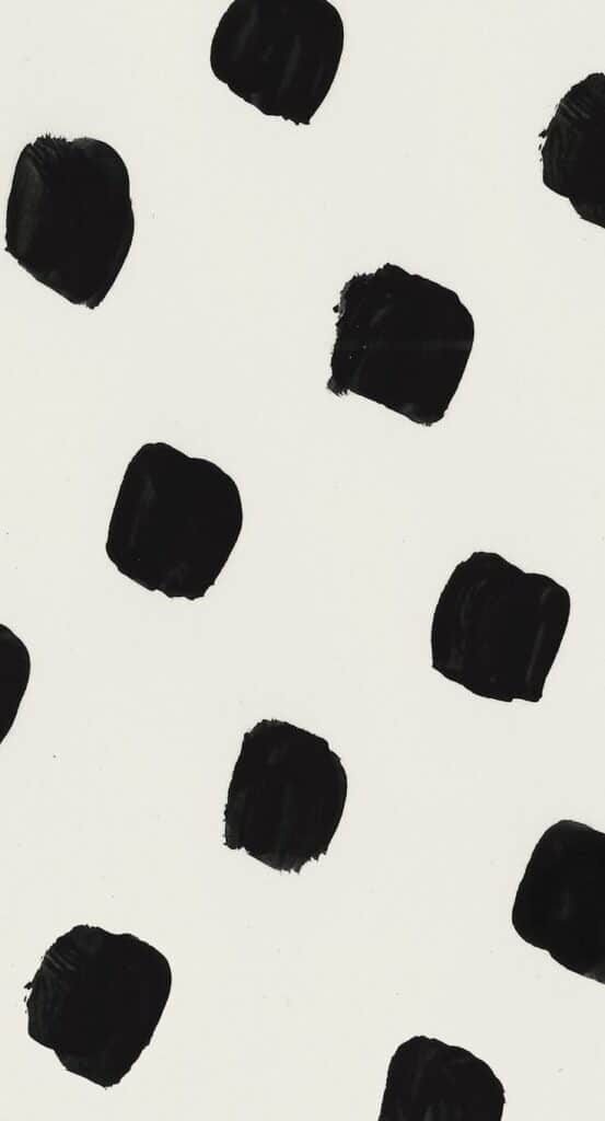 Black brushstroke dots on a white background, creating a bold, minimalist pattern.