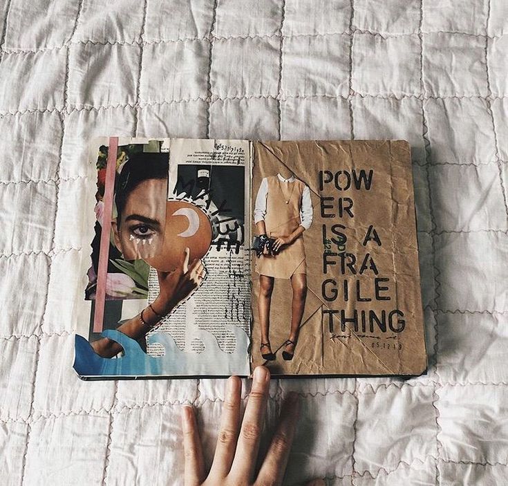 Open journal with collage art and the text Power is a fragile thing, resting on a quilted surface.