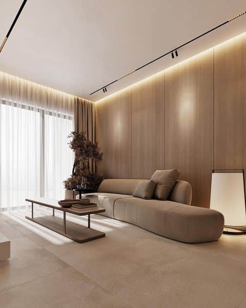 Modern minimalist living room with beige sofa, wooden wall panels, sleek coffee table, and soft lighting.