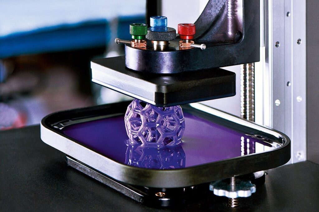 3D printer creating a detailed purple object in liquid resin.
